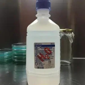Distilled water 1000ml bottle on a laboratory table, ideal for adding humidity to mushrooms and misting mushroom grow kits
