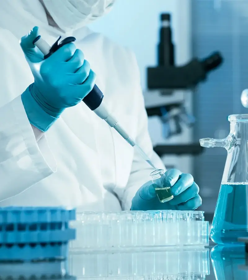 Scientist in a laboratory preparing Psilocybe cubensis spore syringes and high-quality spore solutions for mycologists