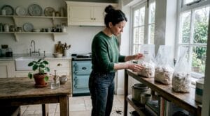 Home grower inspecting mushroom bags on shelf